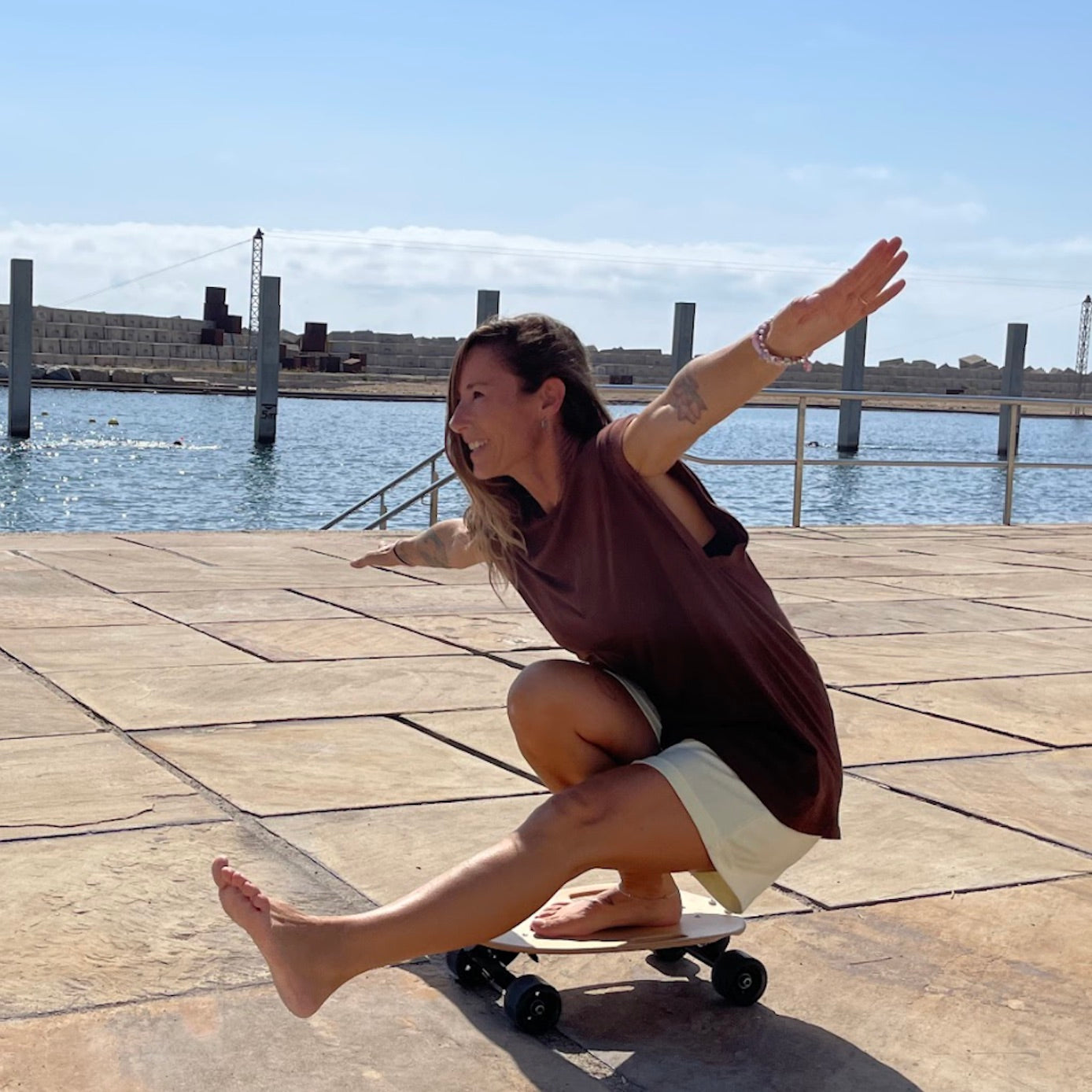A Spanish girl gliding down Barceloneta on a weekend for a fun outdoor activity