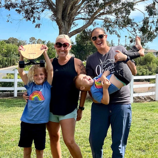 A happy family, including two kids and two moms, celebrate after successfully assembling their first Elos skateboard. This is a great alternative to a penny board skateboard and other different types of skateboards. You can find it sometimes holding mini longboard sale each year.