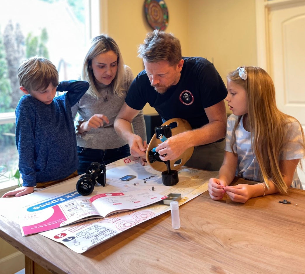A family working together to assemble Elos DIY skateboard kit 