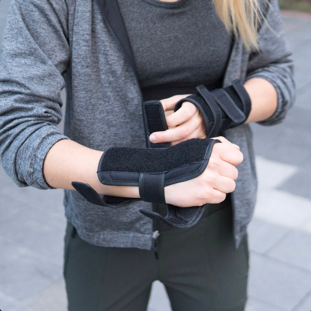 A girl is wearing Elos wrist guards as a outdoor safety equipment